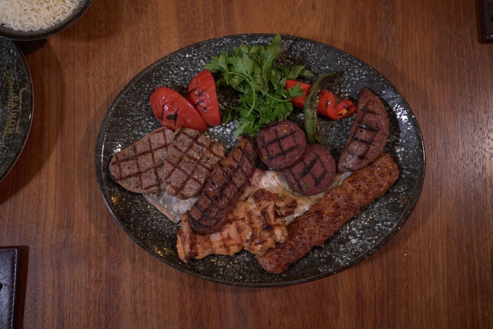 A loaded mixed grill platter of sausages, chops and grilled meats